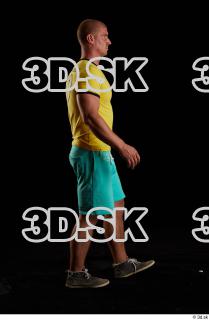 Walking reference of yellow shirt turquoise shorts brown shoes Leland…